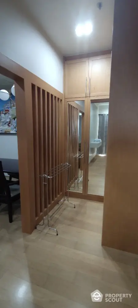 Modern interior hallway with wooden accents and mirrored closet doors