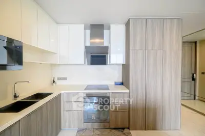 Modern kitchen with sleek cabinetry and built-in appliances in a stylish apartment.