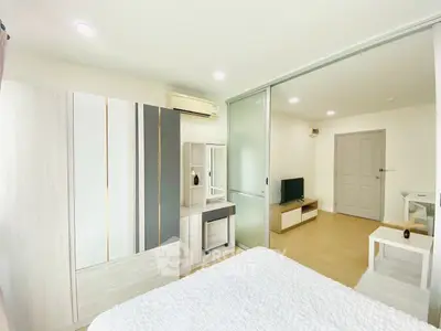 Modern bedroom with sliding glass doors and stylish furniture