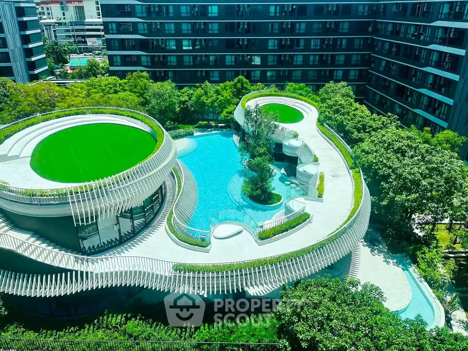 Luxurious modern apartment complex with stunning rooftop pool and lush greenery.