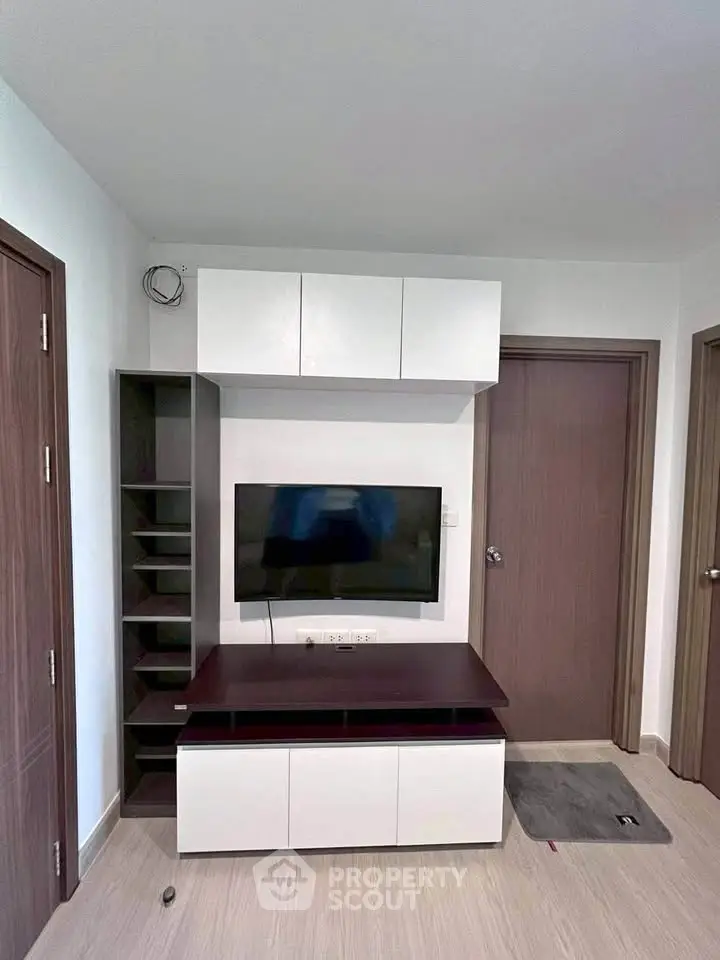 Modern living room with sleek TV unit and storage cabinets
