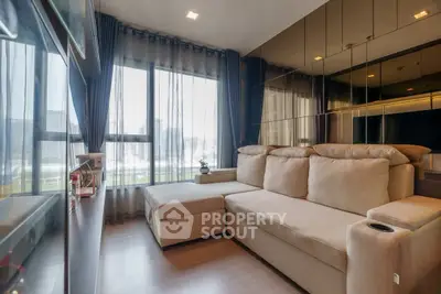 Modern living room with large windows and comfortable beige sofa