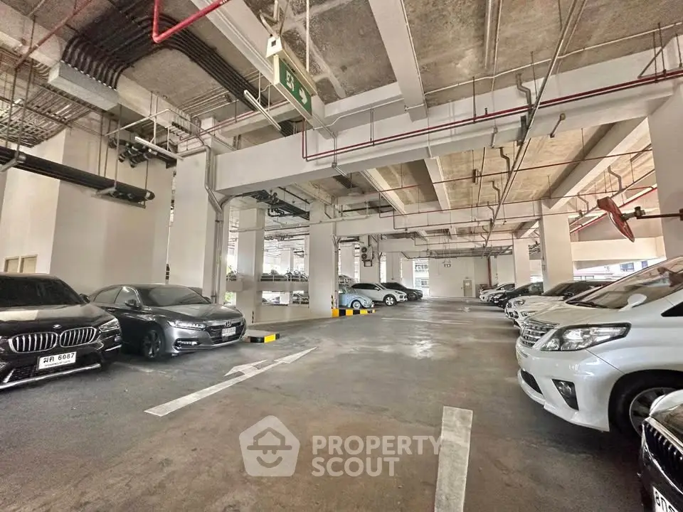 Spacious indoor parking area with multiple cars in a modern building