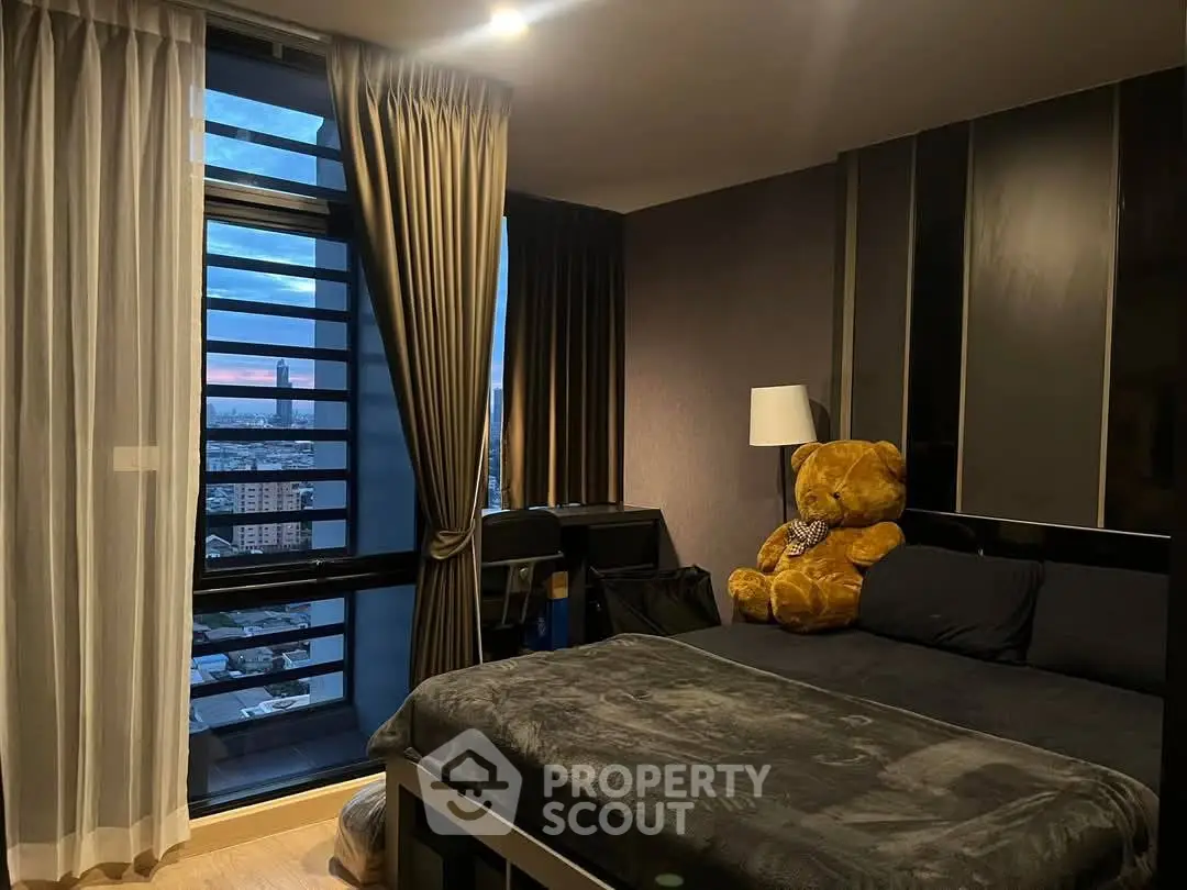 Cozy bedroom with city view and plush teddy bear decor