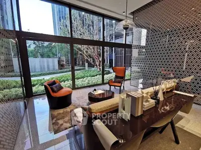 Luxurious modern living room with floor-to-ceiling windows and elegant furniture overlooking a lush garden.