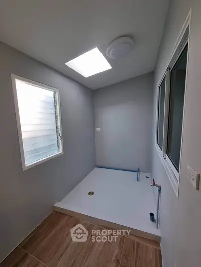 Modern minimalist bathroom with skylight and sleek design