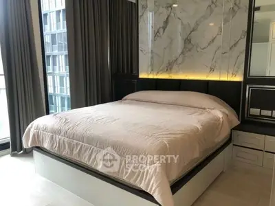 Luxurious modern bedroom with marble accent wall and elegant lighting
