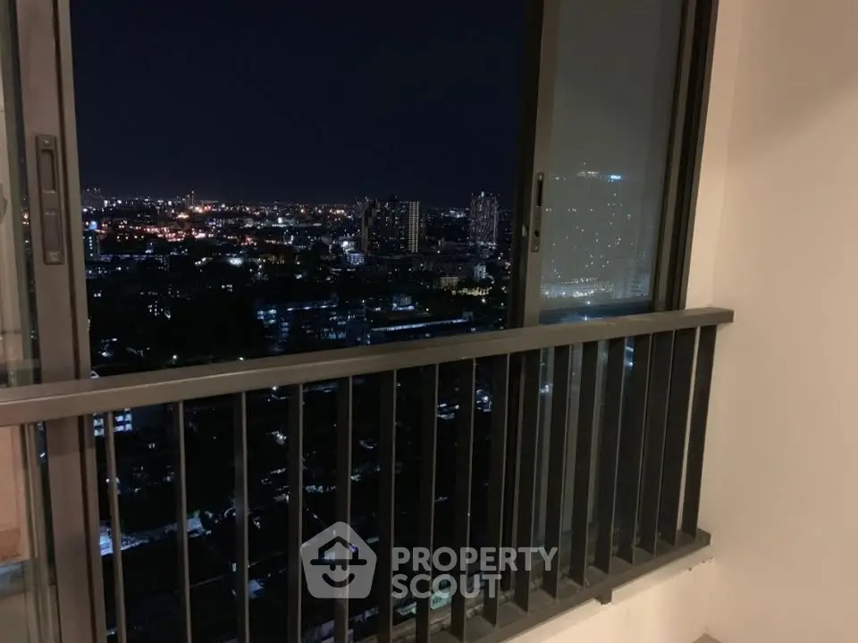Stunning cityscape view from a high-rise balcony at night, perfect for urban living enthusiasts.