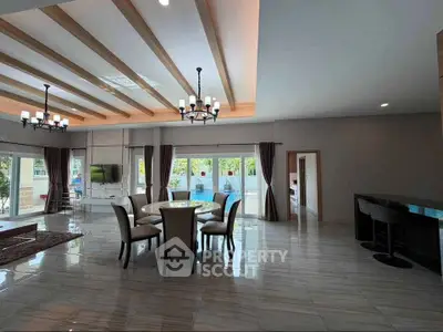 Spacious modern living room with elegant dining area and large windows.