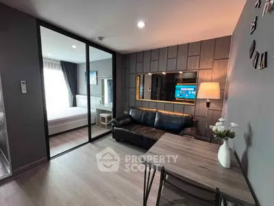 Modern apartment interior with stylish living room and cozy bedroom separated by glass partition.