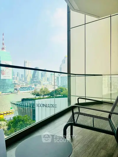 Stunning city view from a modern balcony with sleek glass railing and stylish seating.