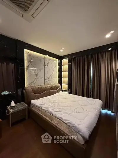 Luxurious bedroom with elegant lighting and modern decor, featuring a plush bed and stylish curtains.