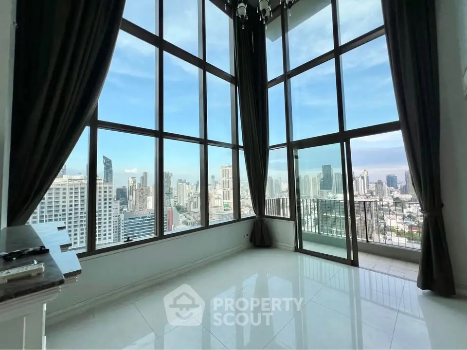 Stunning high-rise apartment with floor-to-ceiling windows and breathtaking city view.