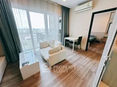Modern living room with wooden flooring and balcony view in a stylish apartment