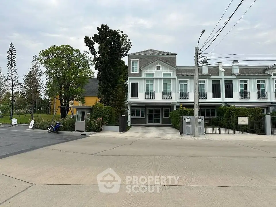 Charming townhouse with elegant facade and lush greenery in a serene neighborhood.
