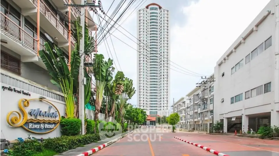 Stunning high-rise building with lush greenery and modern architecture in a vibrant urban setting.