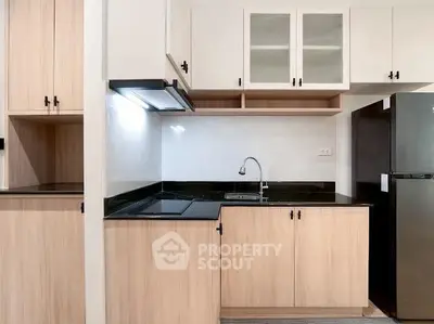 Modern kitchen with sleek cabinetry and black countertops