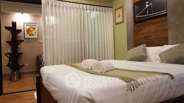 Cozy bedroom with modern decor and elegant lighting, perfect for relaxation.