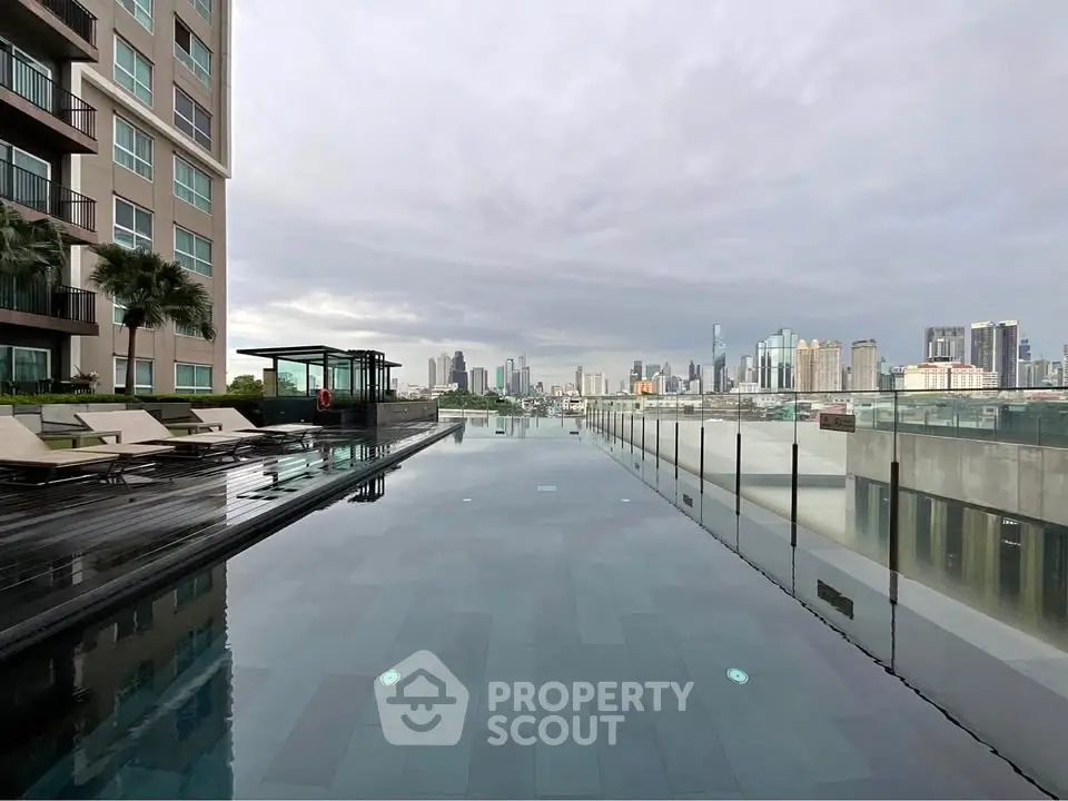 Luxurious rooftop pool with stunning city skyline view in modern high-rise building.