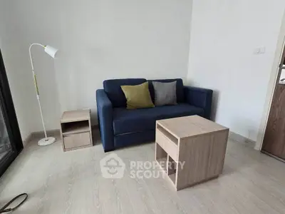Cozy living room with modern blue sofa and wooden furniture