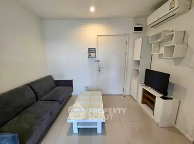 Modern living room with sleek furniture and air conditioning, perfect for comfortable living.