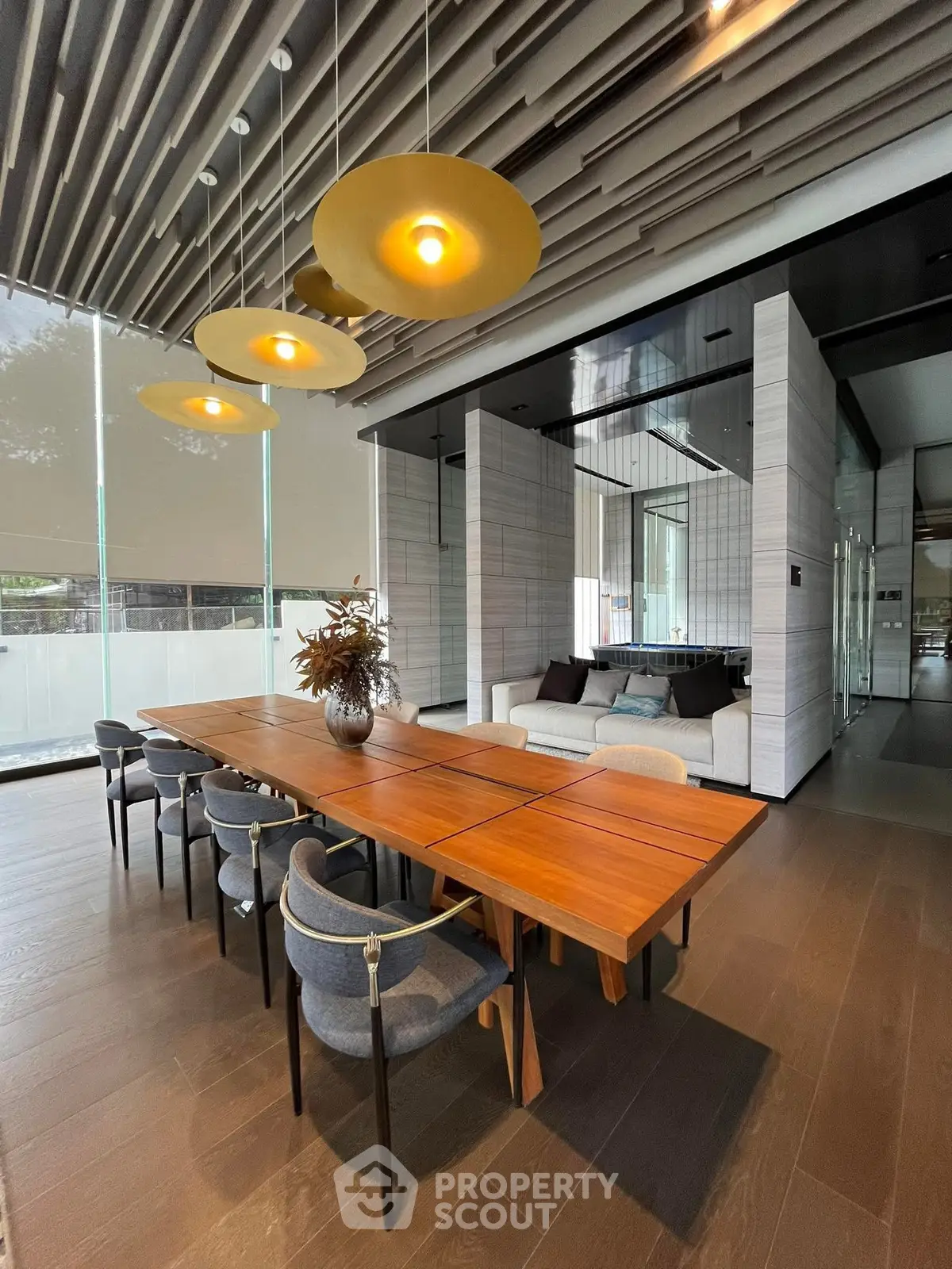 Luxurious modern dining area with elegant wooden table and stylish chairs, perfect for sophisticated gatherings.