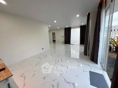 Spacious modern living room with marble flooring and large windows