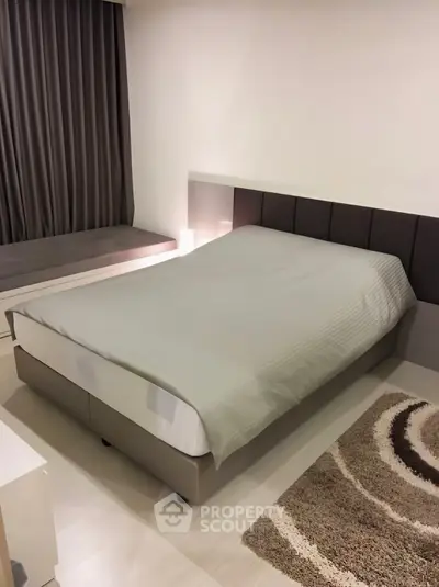 Modern bedroom with stylish decor and cozy ambiance, featuring a comfortable bed and elegant furnishings.