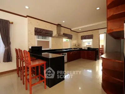 Spacious modern kitchen with sleek black countertops and open layout