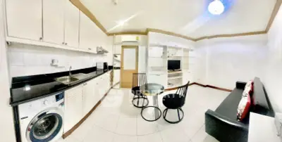 Modern kitchen and living area with sleek design and integrated appliances