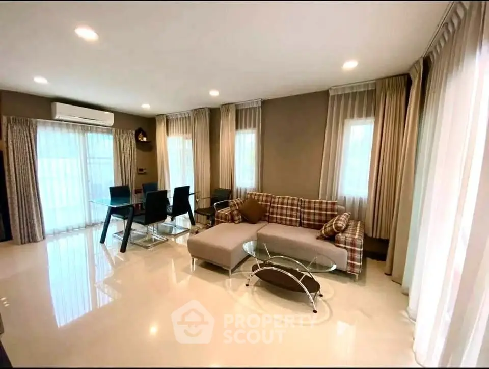 Spacious modern living room with elegant decor and ample natural light.