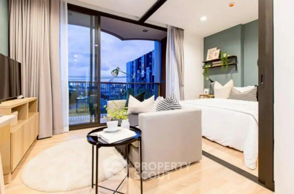 Modern studio apartment with cozy living area and balcony view