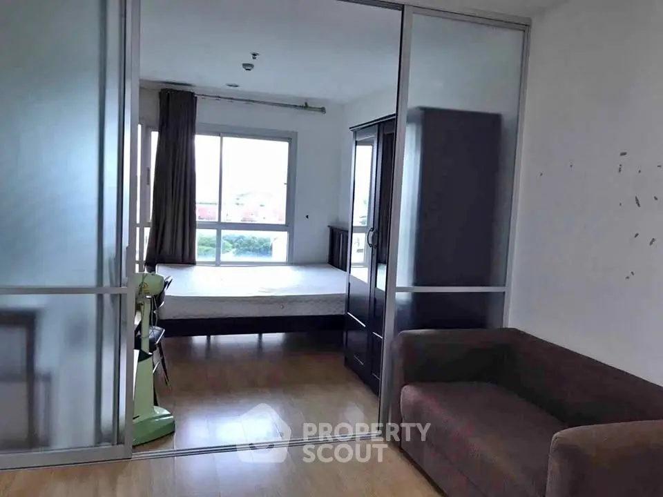 Spacious bedroom with sliding glass doors and natural light