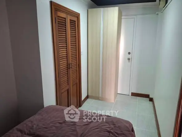 Cozy bedroom with wooden closet and modern wardrobe