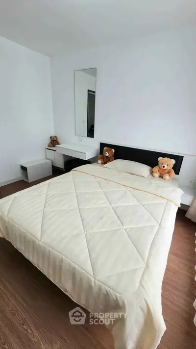 Cozy bedroom with modern decor and plush teddy bears on the bed, perfect for a serene retreat.