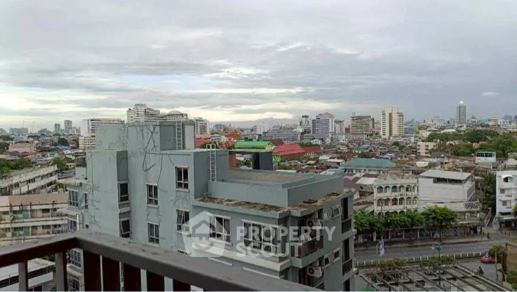 Stunning cityscape view from a high-rise balcony, showcasing urban skyline and vibrant city life.