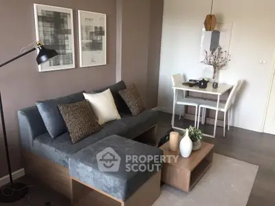 Modern living room with stylish furniture and dining area, perfect for cozy gatherings.