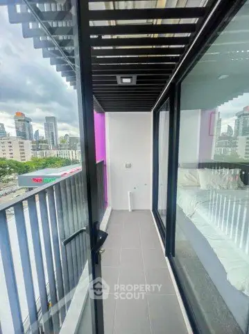 Modern apartment balcony with city view and glass railing