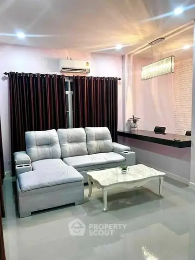Modern living room with elegant sofa and stylish lighting in a cozy apartment.