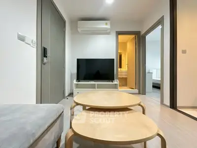 Modern living room with minimalist furniture and wall-mounted TV