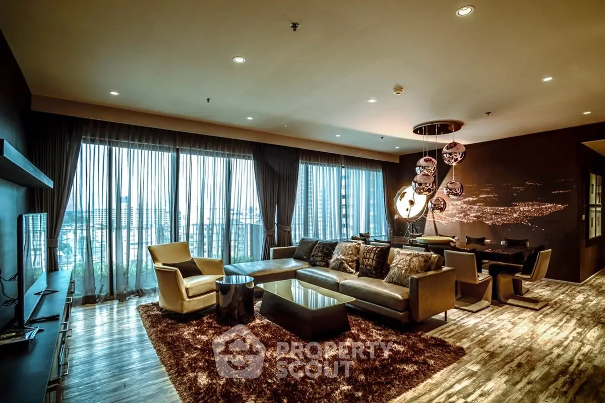 Luxurious living room with modern decor and city view, featuring plush seating and elegant lighting.
