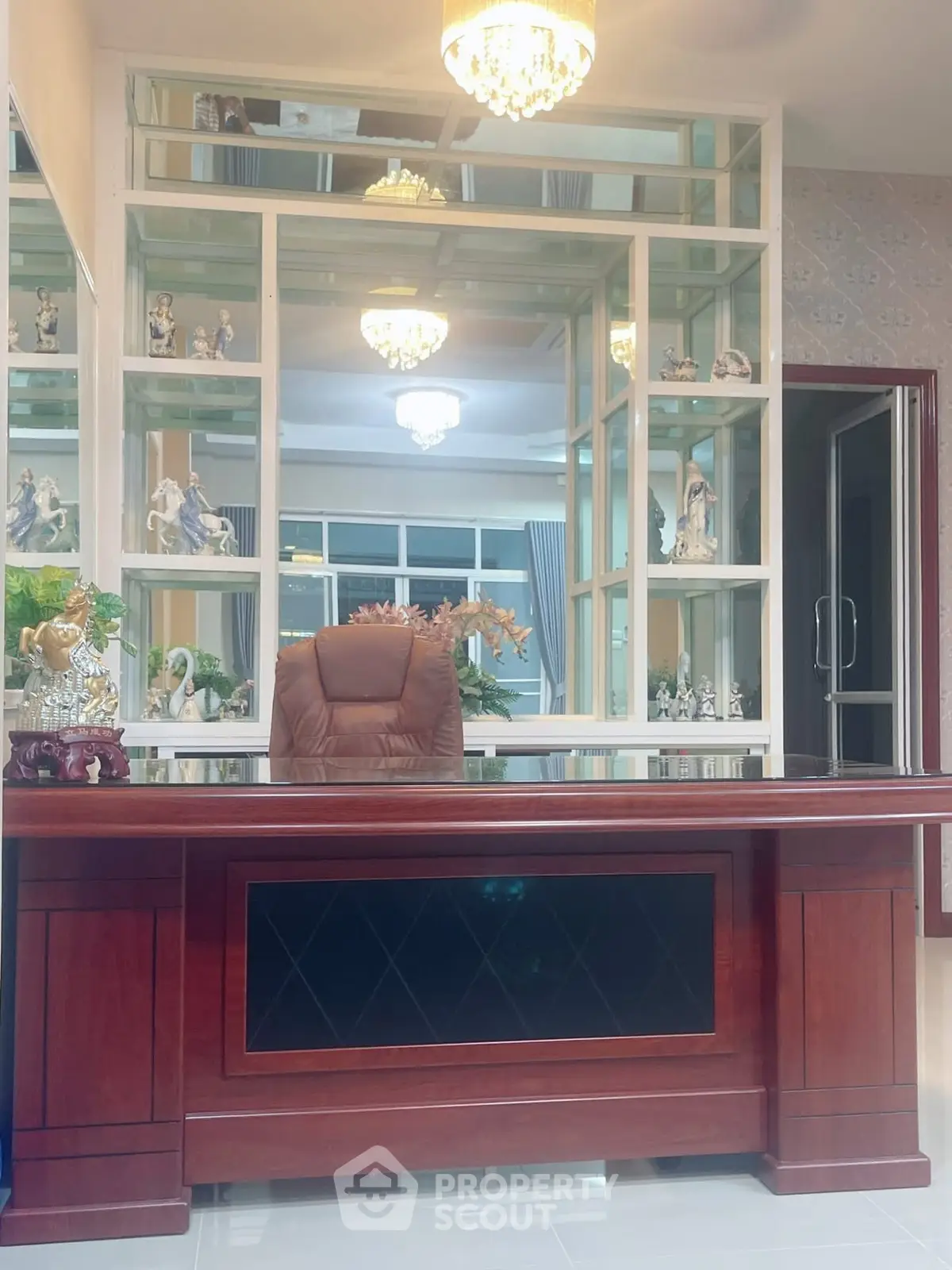 Elegant home office with luxurious wooden desk and decorative shelving