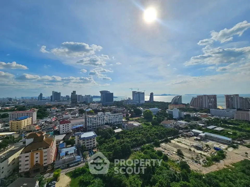 Stunning cityscape view with ocean backdrop and lush greenery, perfect for urban living.