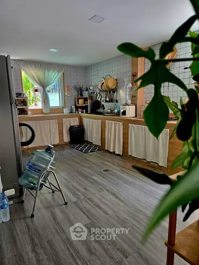 Charming kitchen with rustic decor and ample natural light, featuring modern appliances and cozy ambiance.
