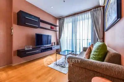 Modern living room with stylish decor and large window for natural light.