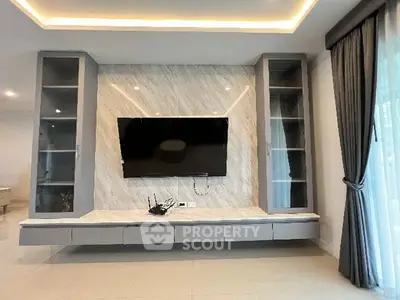 Modern living room with sleek TV setup and elegant lighting