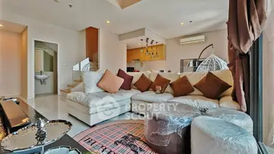 Luxurious living room with modern decor and open kitchen layout