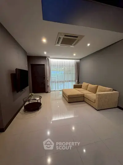 Modern living room with sleek design and comfortable beige sofa