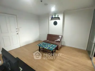 Cozy living room with minimalist decor and wooden flooring