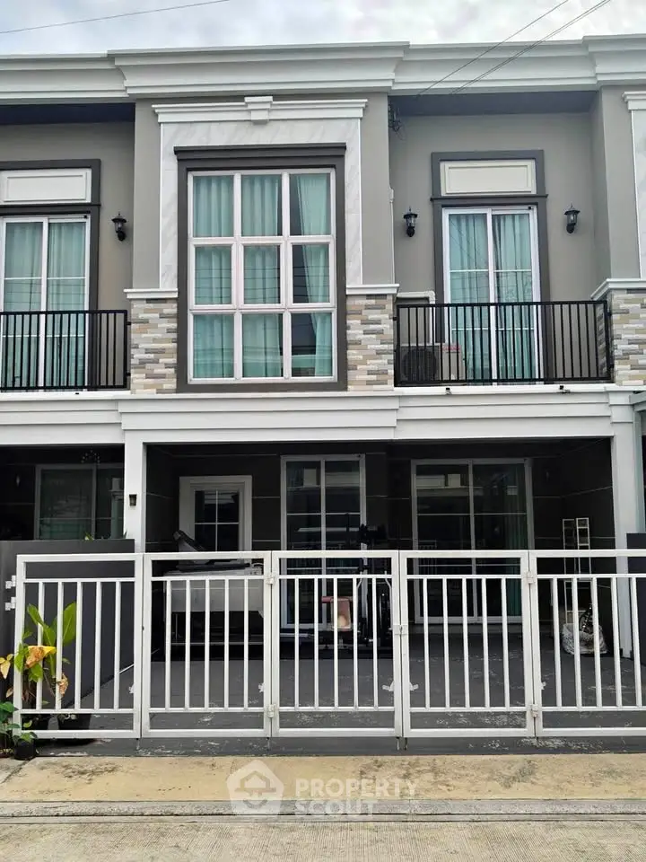 Modern townhouse exterior with stylish facade and gated entrance, perfect for urban living.